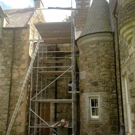 Scaffolding erected beside a tower of a traditional building