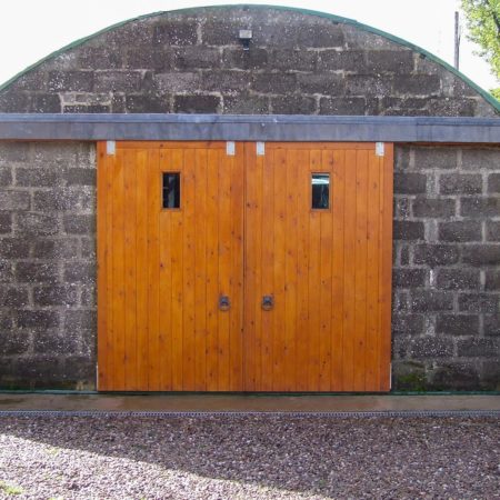 Two large wooden doors on sliding frame