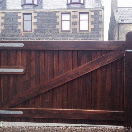 Wooden gate with three hinges to left and bolt to upper right