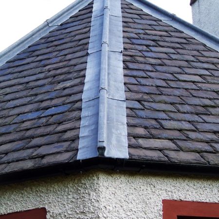 Grey slate roof with lead flashings