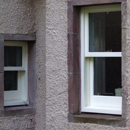 Small white wood window to left and larger white window to right