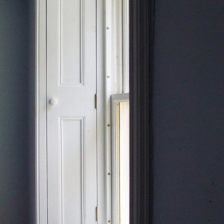 White wooden window with side shutter