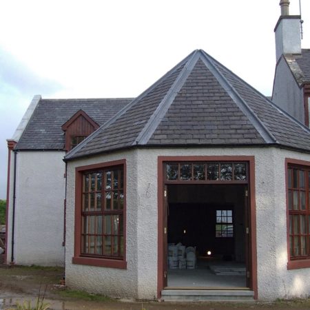 New built conservatory showing panelled windows and open french doors