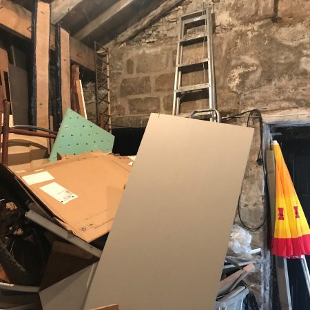 Inside of barn cluttered with items in storage