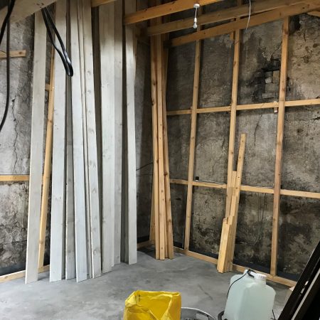 Inside of barn showing wood frame added to stone walls