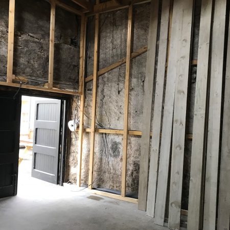 Inside of barn showing wood frame added to stone walls