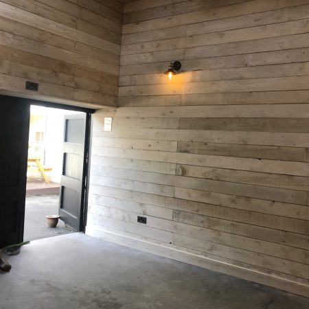 Inside of converted barn building showing wood panelled walls