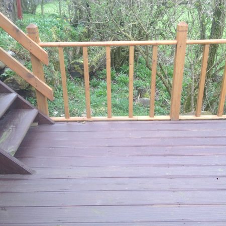 Wooden decked area with handmade wooden staircase rail and handrails